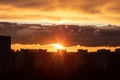 Sunset in the city of Moscow, the sun sets behind residential buildings, beautiful red clouds Royalty Free Stock Photo