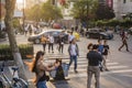 Sunset city scenery, pedestrians, traffic flow.