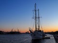 Sunset cityscape with old sailing ship Royalty Free Stock Photo