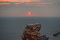 Sunset by the cliff. Sunset mood at the rock `Tall Anna` with flying birds. View of the rock `Lange Anna` by sunset in summer, Hel Royalty Free Stock Photo