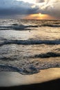 Sunset with clouds, bird and waves