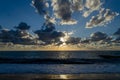 Sunset clouds hiding the sun over the sea, with shadows Royalty Free Stock Photo