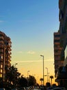 Sunset clouds houses palm trees GTA cars Royalty Free Stock Photo