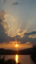 sunset with clouds light rays over the mountains and river with reflections, Thailand Royalty Free Stock Photo