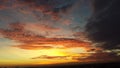 A beautiful yellow, red, orange and blue sunset in the clouds over Curitiba, Brazil with black clouds Royalty Free Stock Photo