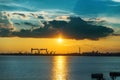 Sunset in clouds over river and shipbuilding factory Royalty Free Stock Photo