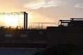 Sunset cloudscape over an industrial area with special electrical types of equipment and locked gate Royalty Free Stock Photo