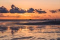 Sunset on a cloudy colorful sky over the North Sea in Denmark with high reflection in the water Royalty Free Stock Photo
