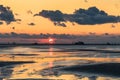 Sunset on a cloudy colorful sky over the North Sea in Denmark with high reflection in the water Royalty Free Stock Photo