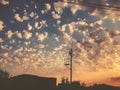 Sunset cloudy sky with picturesque clouds lit by warm sunset sunlight. Country road at sunset Royalty Free Stock Photo