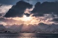 Sunset in cloudy on snowy mountain range in Senja island Royalty Free Stock Photo