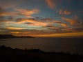 Dramatic colorful sunset in the coast of Oran with mountains in the backgrounnd, Algeria