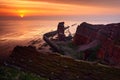 Sunset on the coast. Sea with sun. Rock coast with sun during sunset. Sunset at Helgoland in Germany. Beautiful landscape with ora
