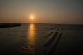 The sunset on the coast of Tainan reflects the oyster racks in the lagoon!