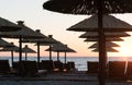 Sunset in the coastal town of Bar with silhouettes of umbrellas on the beach.