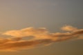 Sunset colored clouds in blue sky for background