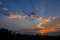 Sunset, colorful summer landscape. Clouds lit by the orange rays of the sun against the blue evening sky Royalty Free Stock Photo