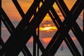 Sunset colors as seen through girders of fishing pier Royalty Free Stock Photo