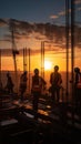 At sunset, construction site silhouettes include crane and diligent workers Royalty Free Stock Photo