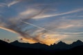 Sunset and contrail over mountains