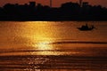 Sunset, Country boat heading towards golden rays Royalty Free Stock Photo