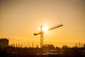 Sunset through a crane in industrialized area of city Royalty Free Stock Photo