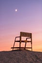 Sunset and crescent moon over a lifeguard tower. Long Beach, NY