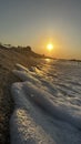 Sunset at the beach with sand and waves Royalty Free Stock Photo