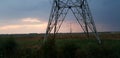 Sunset and dark clouds between power line towers in the Eendragtspolder in Zevenhuizen, The Netherlands Royalty Free Stock Photo