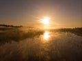 Sunset or dawn on a morning lake or swamp, steam and haze Royalty Free Stock Photo