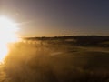 Sunset or dawn on a morning lake or swamp, steam and haze Royalty Free Stock Photo