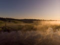 Sunset or dawn on a morning lake or swamp, steam and haze Royalty Free Stock Photo