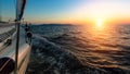 Sunset from the deck of the sailing boat moving in a sea. Travel.