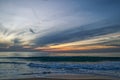 Sri-Lankian beautiful sunset over the sea, waves and cloudy dark sky Royalty Free Stock Photo