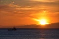 Sunset on the beach of DoniÃÂ±os in Ferrol as a boat passes by