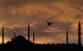 Sunset, dramatic sky and mosque silhouettes