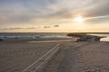 Sunset on empty ocean beach with stone pier. Ocean coast landscape. Evening sky in dusk on seashore. Royalty Free Stock Photo