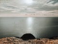 Sunset on the empty rocky shore. Marine landscape in soft palette. A cliff above the sea. Royalty Free Stock Photo