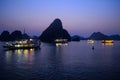 A sunset evening night view of Ha Long Bay in Vietnam with tourist cruise and boats Royalty Free Stock Photo