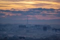 Sunset in the evening over the city in the fog