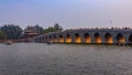 Sunset at the famous 17 arch lion bridge on Kunming Lake by Summer Palace in Beijing China