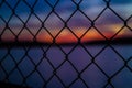 Sunset through a fence Royalty Free Stock Photo