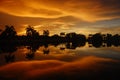 Sunset of fire over the lake and palm trees in the tropical island of Borneo in Kota Kinabalu, Malaysia. Spectacular co Royalty Free Stock Photo