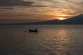 Sunset with fisher man fishing in a boat in ocean near Gili Air Royalty Free Stock Photo