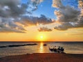 The sunset and the fishermen going home Royalty Free Stock Photo