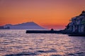 Sunset in fishermen village of Klima, Milos island, Greece. Pair of adults enjoy sunset view on pier of small Royalty Free Stock Photo