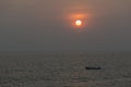 Sunset and fishing boat seen from Anjuna Beach,Goa,India
