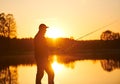 Sunset fishing. fisher with spinning rod Royalty Free Stock Photo