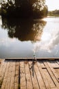 sunset fishing. fisher with spinning rod. Fisherman with rod, spinning reel on the river bank. Fishing for pike, perch Royalty Free Stock Photo