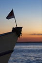 Sunset and flag silhouette on boat cruising the Amazon River, Br